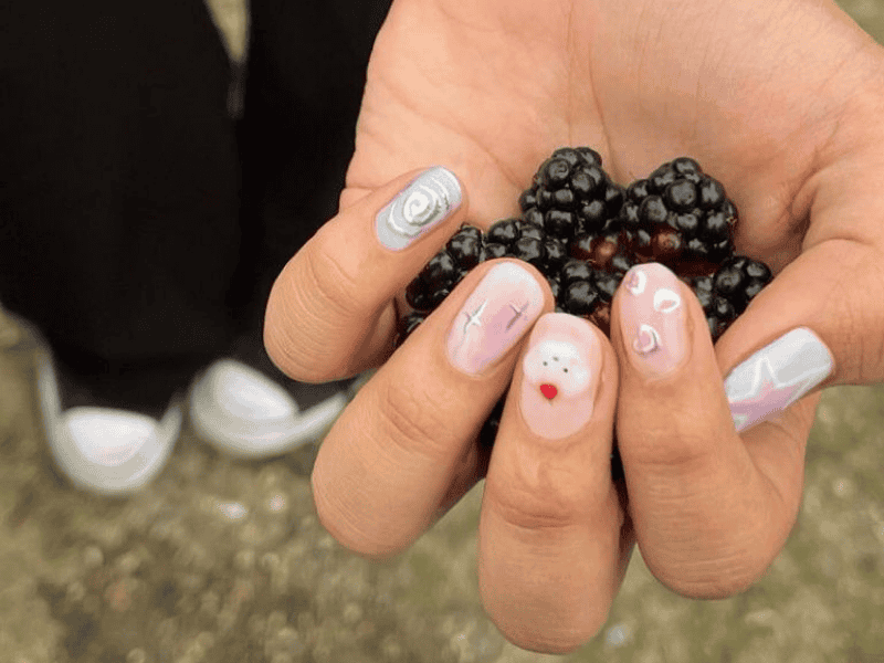 Gel manicure on natural nails by Riri Nails Oman featuring berries and aesthetic nail art