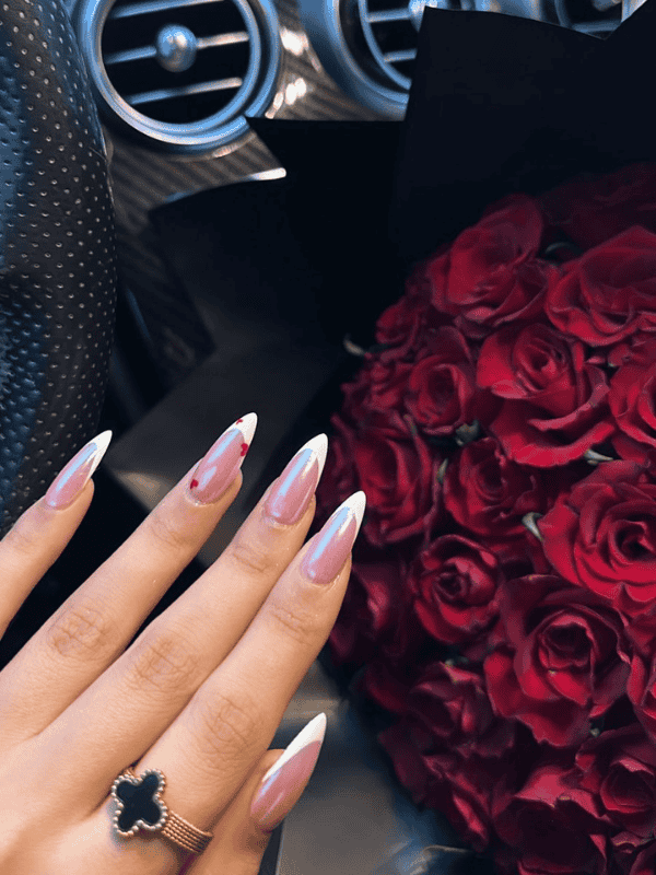 Romantic pink French tip GelX extension nail art with red heart design by Riri Nails in Muscat Oman