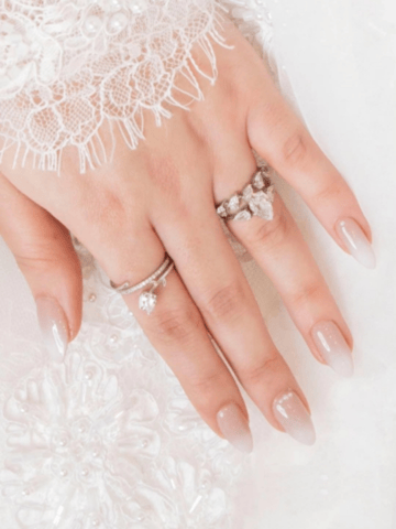 Riri Nails Oman GelX extension with white glacier nail art design featuring sparkle and net sleeves at Muscat