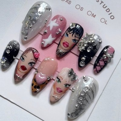 Luxury artistic press-on nails featuring elegant female faces, silver pearls, and star embellishments handcrafted by Riri Nails in Muscat, Oman